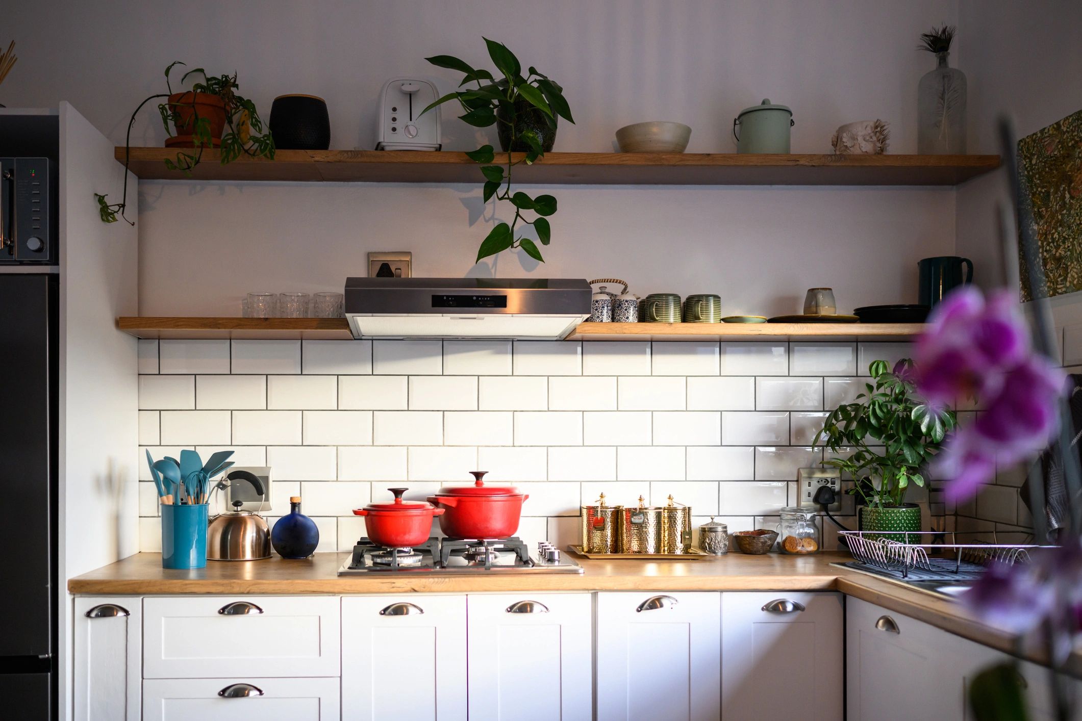 Bright farmhouse-style kitchen with white cabinets and warm, homey details